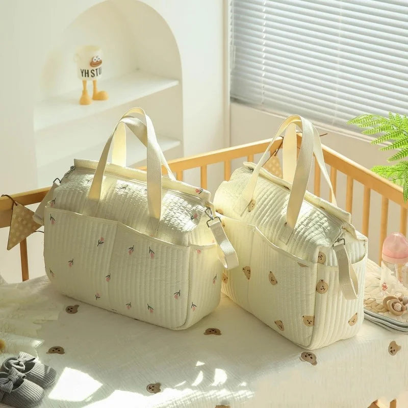 Sac à langer pour maman dans lit bébé